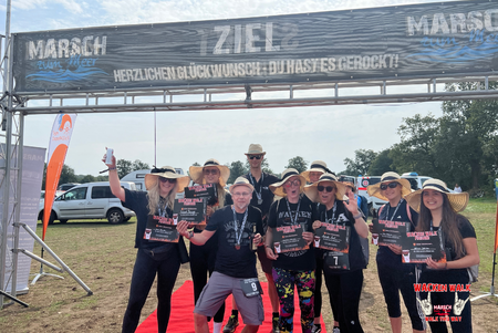 Abbildung einer Gruppe Läufer vom Wacken-Walk Marsch zum Meer im Ziel